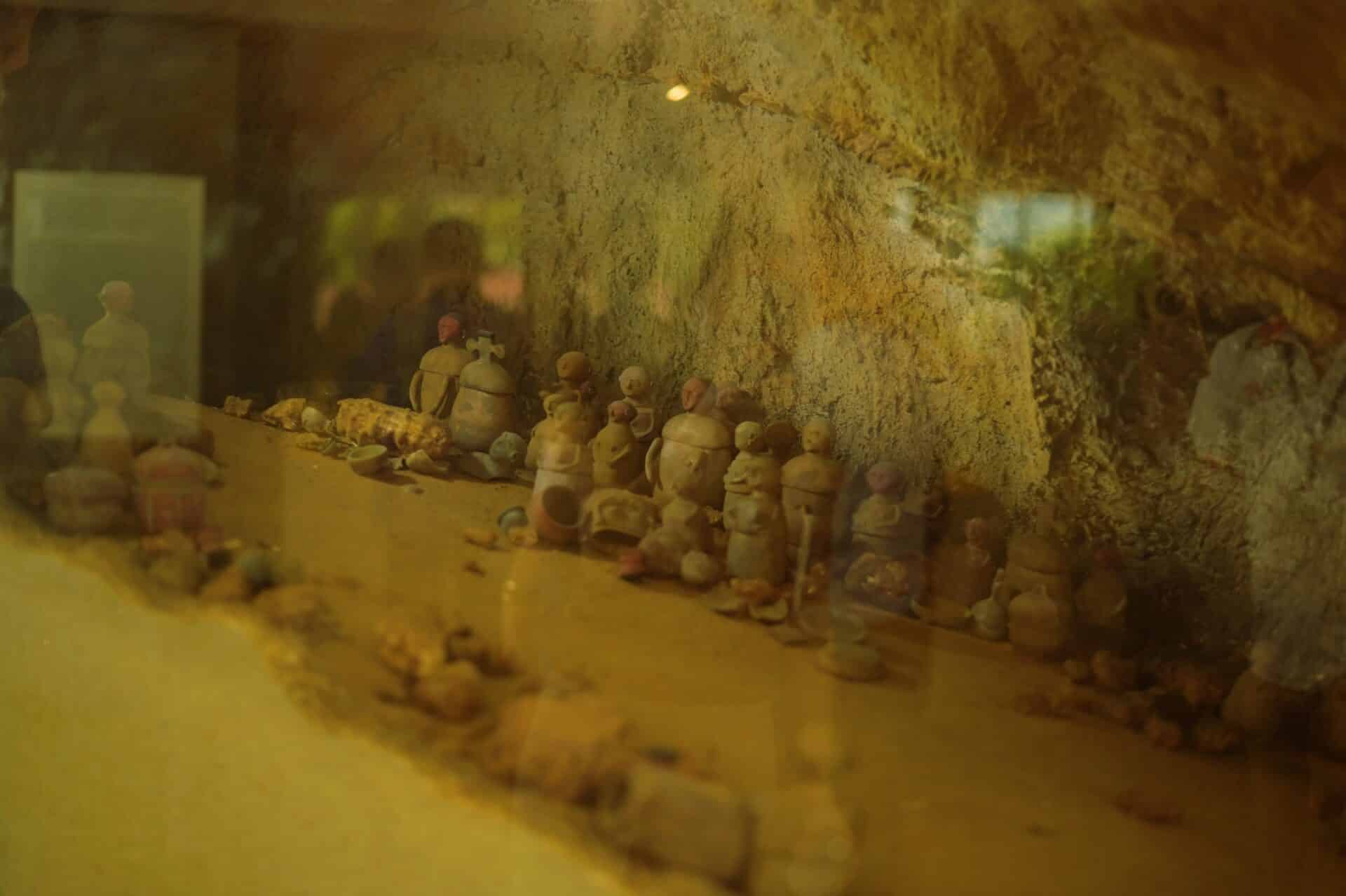 The Maitum jars behind glass at a museum.